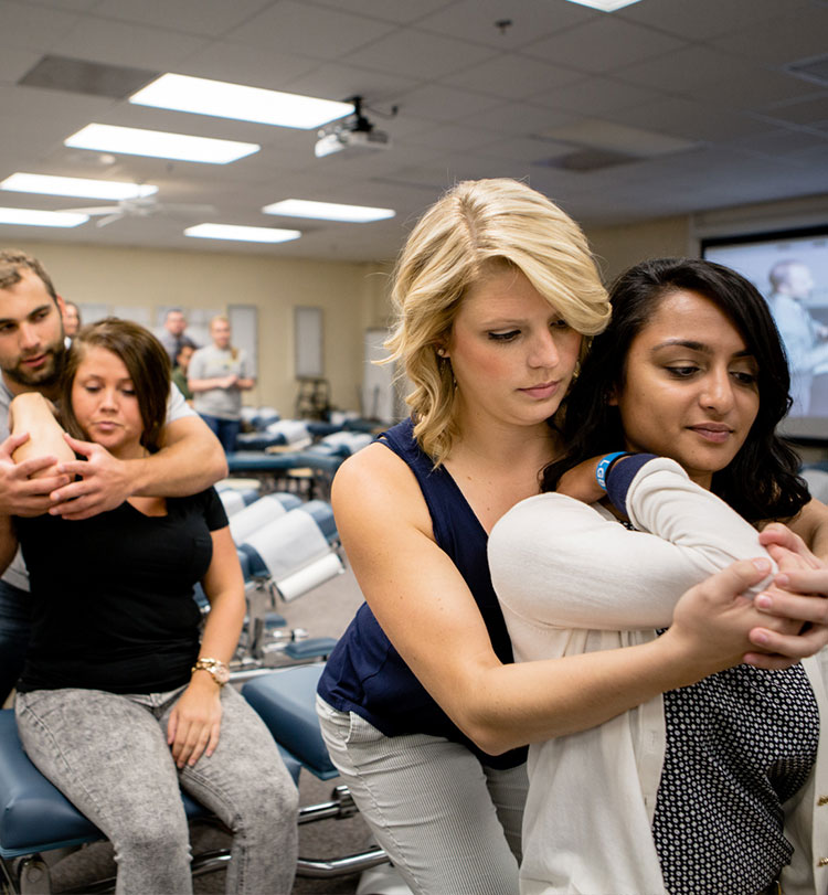 Students practicing techniques on each other in class.