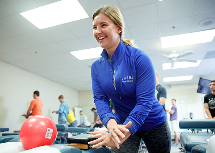 Chiropractic student studying in a hands-on environment.