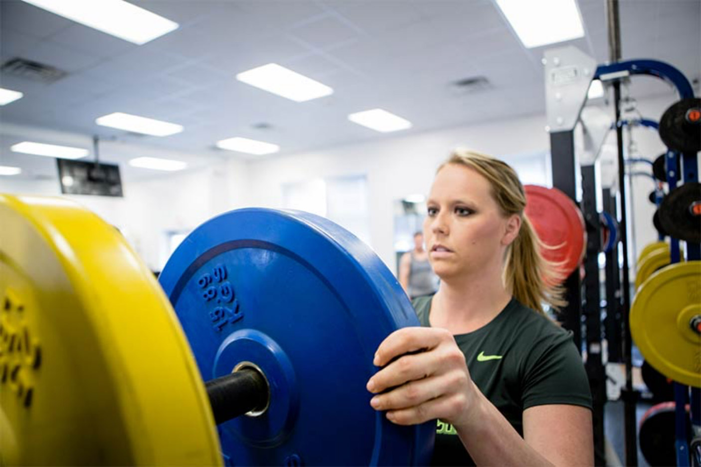 Student in weight room exercising