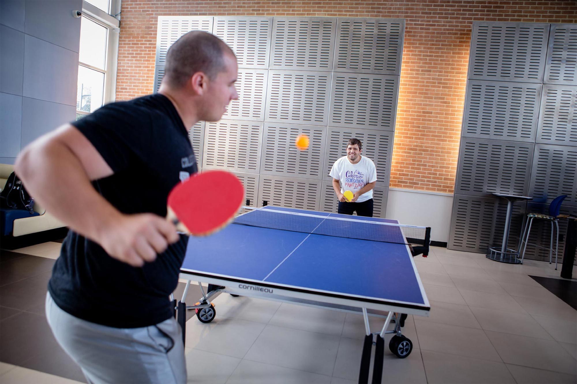 Students playing ping pong.