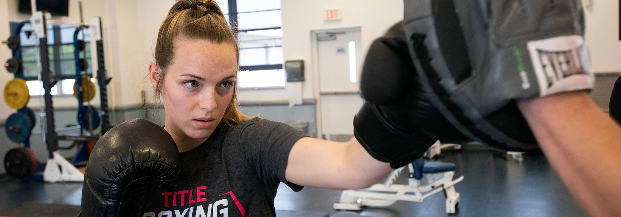 Female boxer working with trainer.