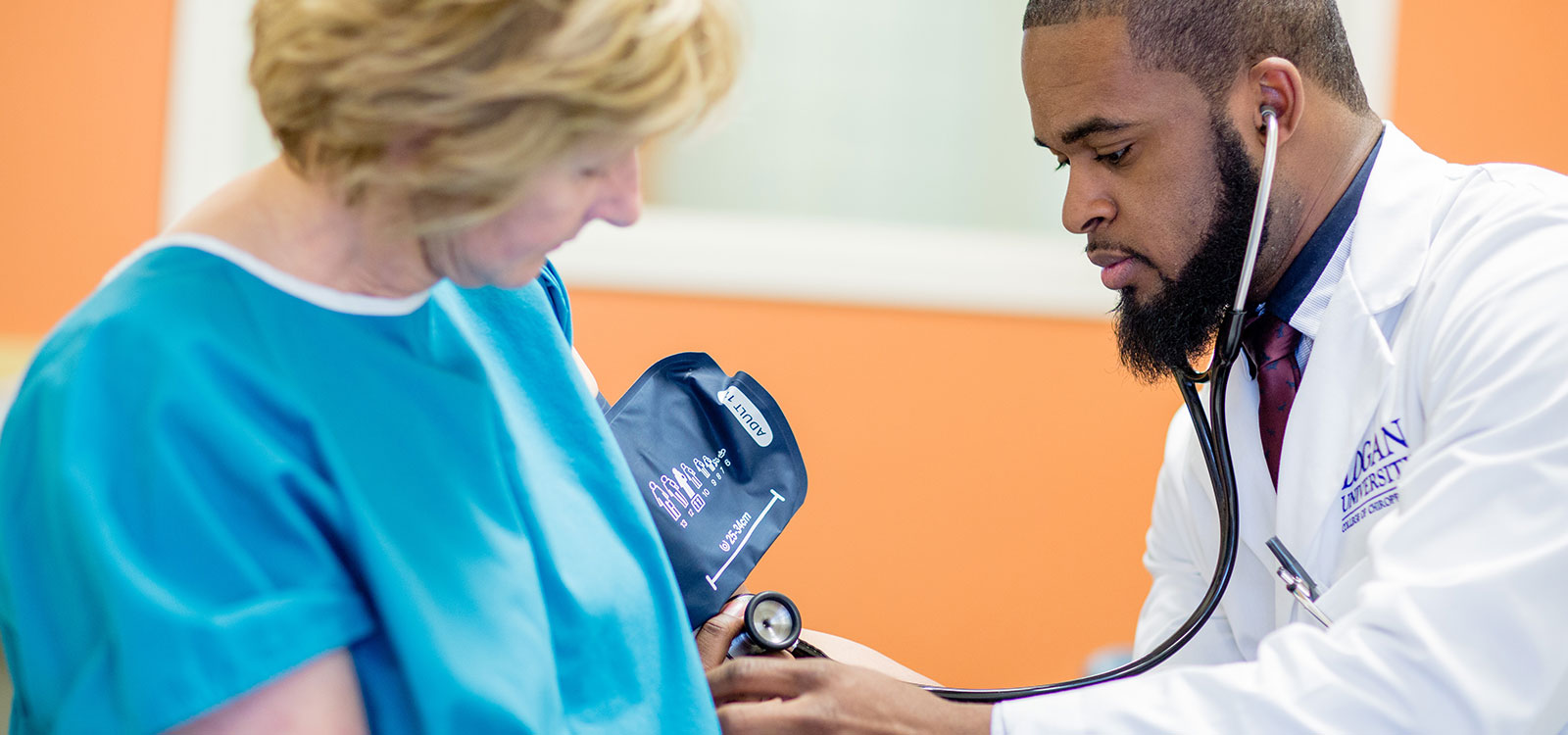 Logan student working with patient.