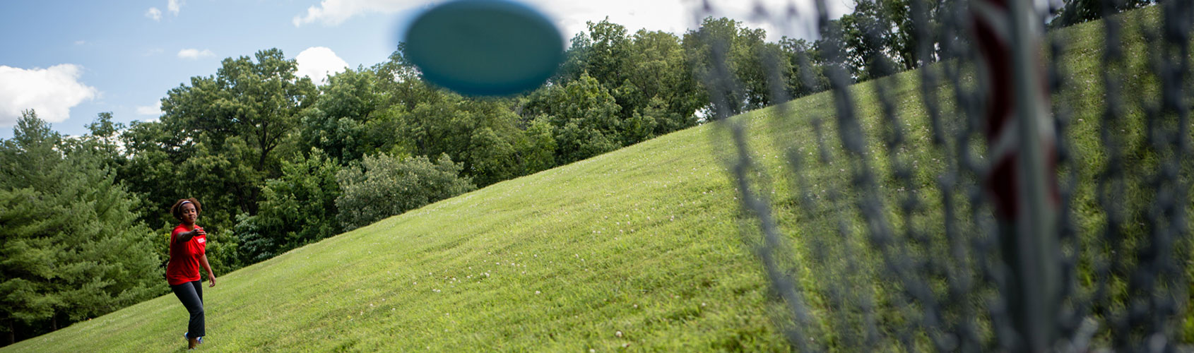 disc-golf-full-width Female student playing disc golf.