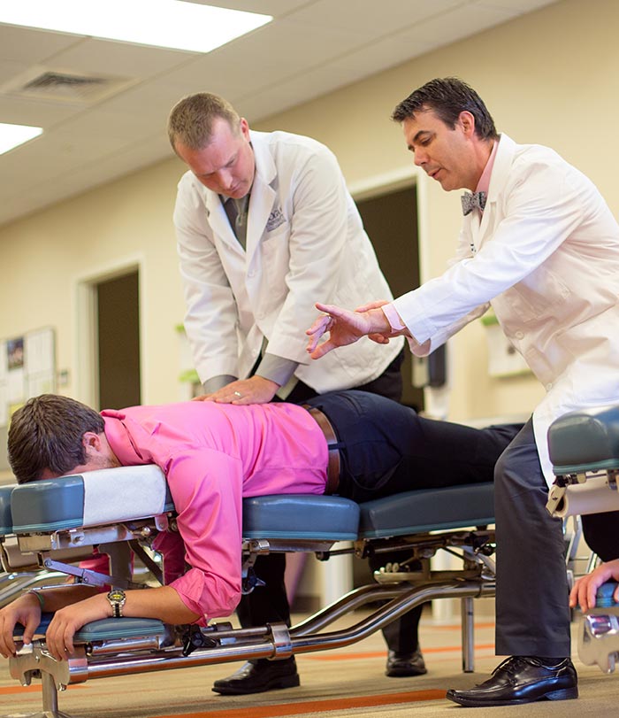 Instructor teaching student adjusting technique.