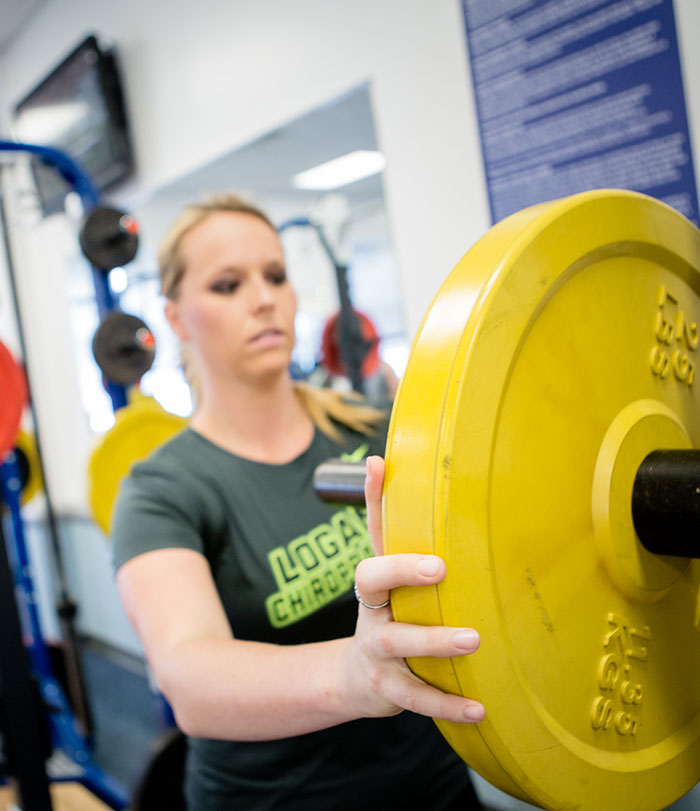 Female student working out in the fitness center.