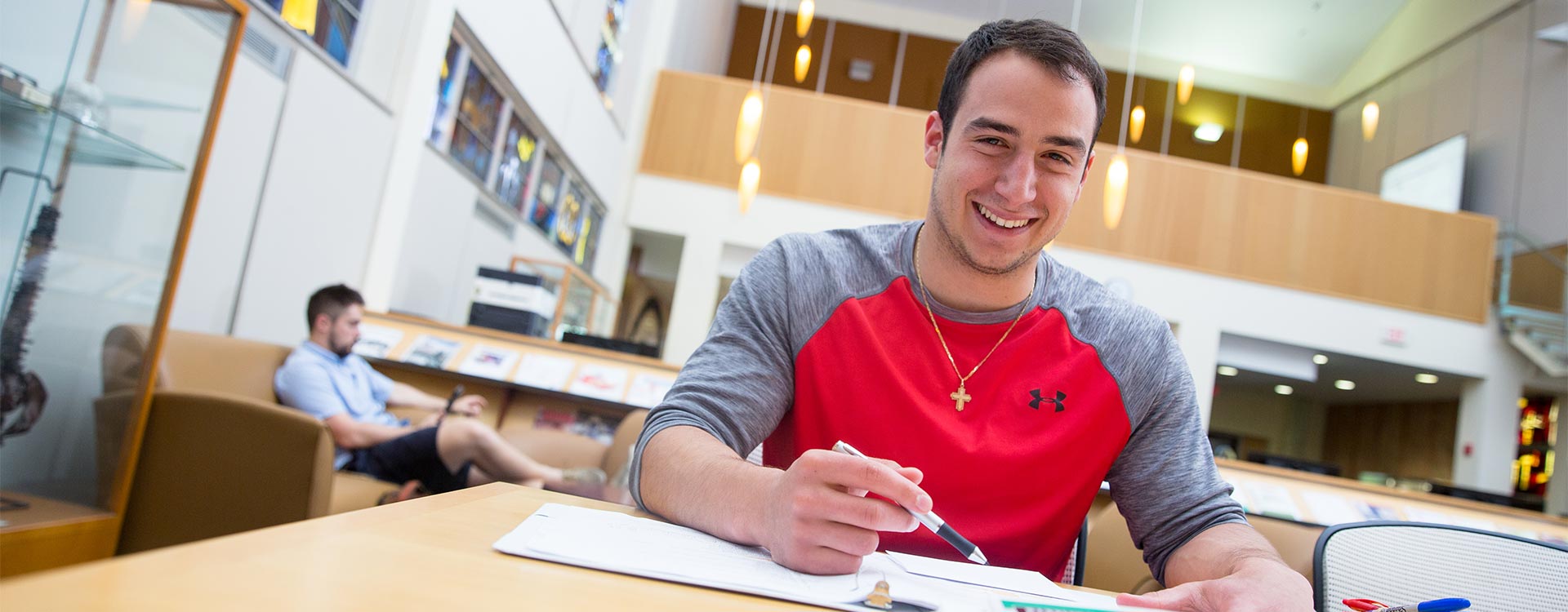 Male student in library studying.