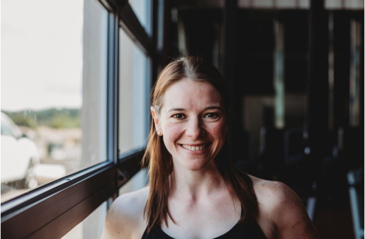 Woman smiles near window